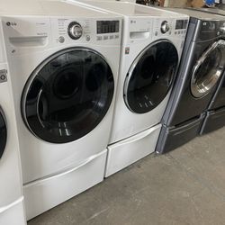 LG front load washer and electric dryer on pedestal with 90 day warranty