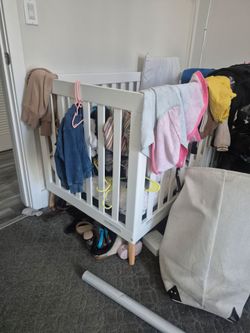 White Mini Baby Crib with Natural Wood Legs