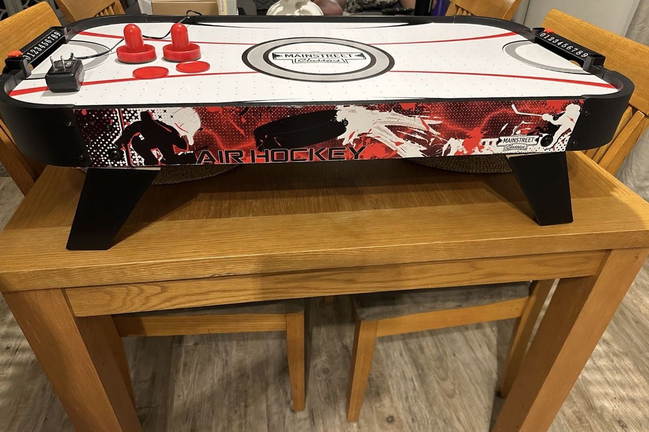 35" Table Top Hockey with Manual Scoreboard. Comes with two strikers and two pucks
