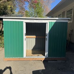 Metal shed on pressure treated deck.