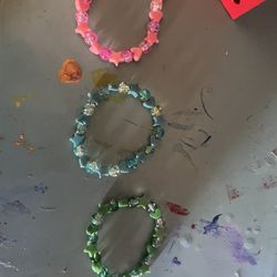 Three Pink, Green, And Blue Bracelets 