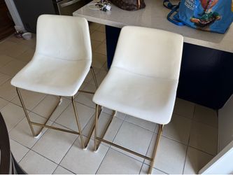 Beige leather bar stools with gold trim