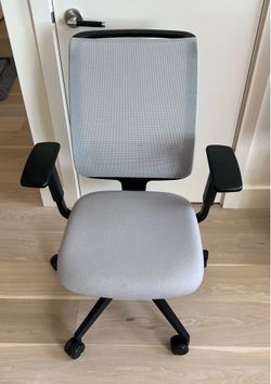 Steelcase Reply task chair with a mesh back and light gray seat fabric