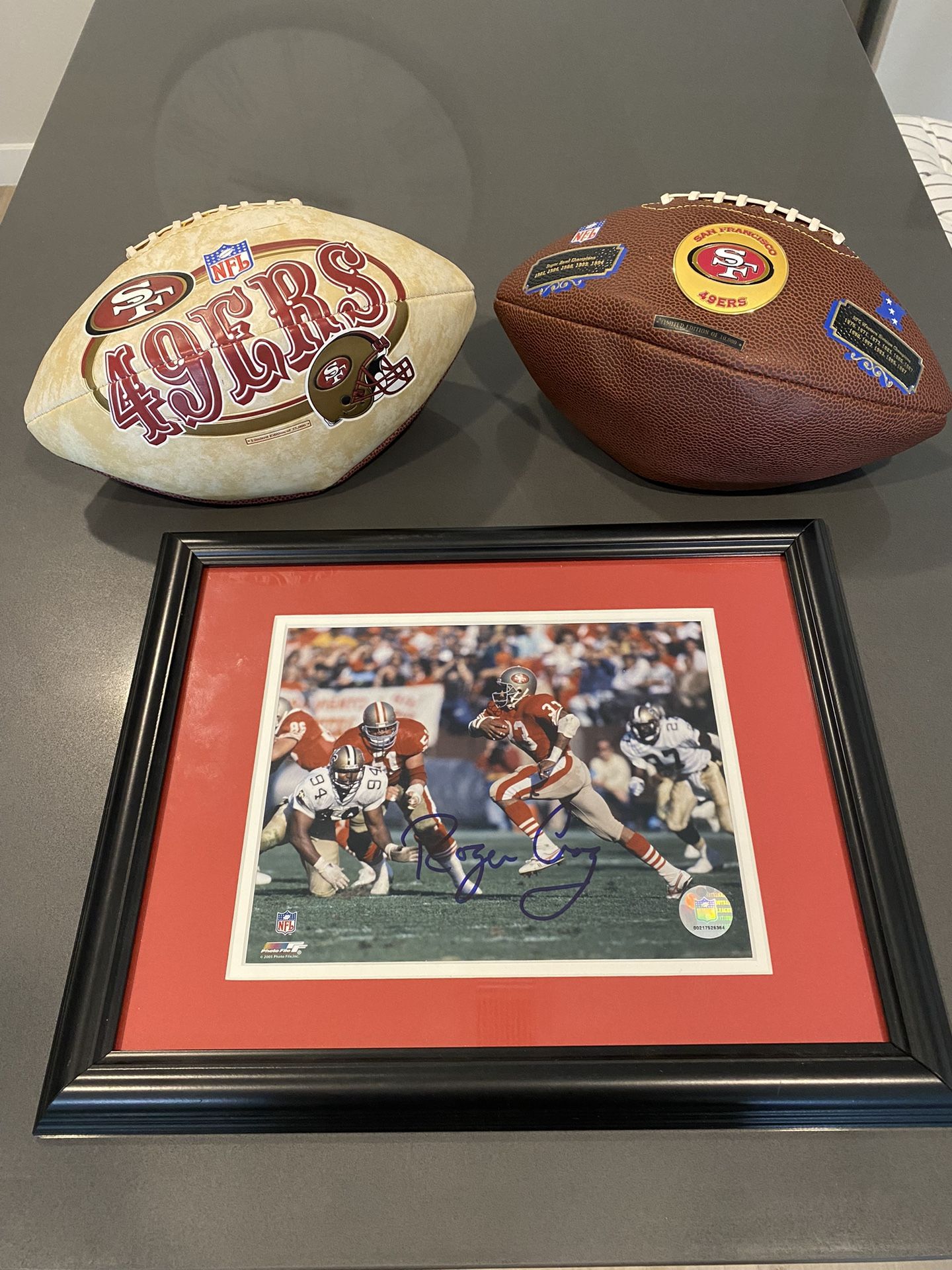 49ers Roger Craig Autographed Framed Photo W/ Two 49ers Collectors Footballs.