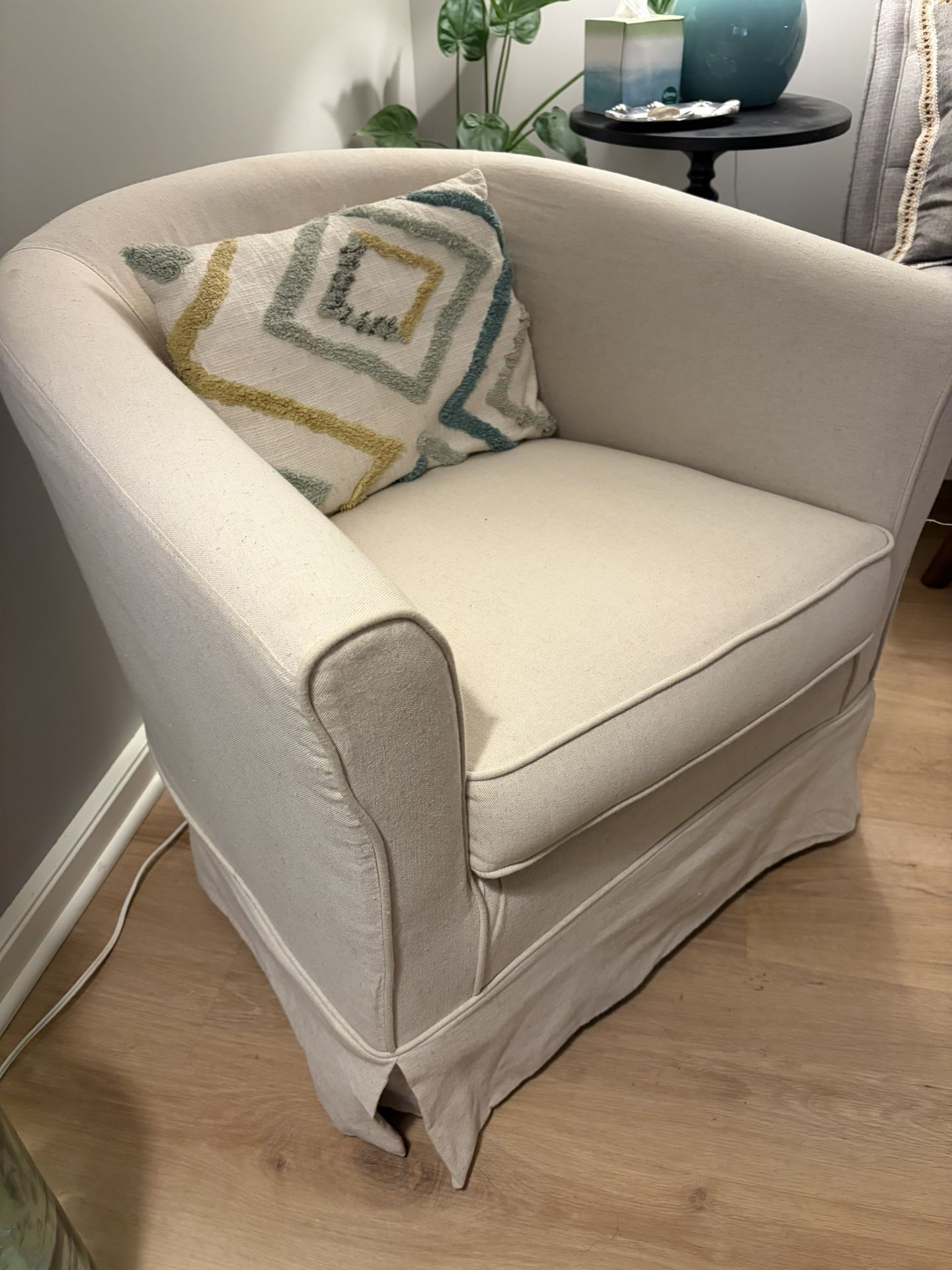 Two Cream Swivel Armchairs 