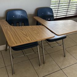 Two chairs with wooden desk arm