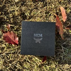 MCM Claus Reversible Leather Belt with a gold-plated M buckle.