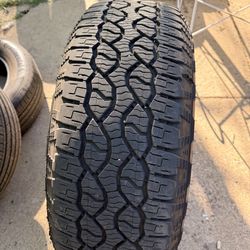 Single Tire GOODYEAR WRANGLER TERRITORY AT 275/65R18 116T. Has 2 patches