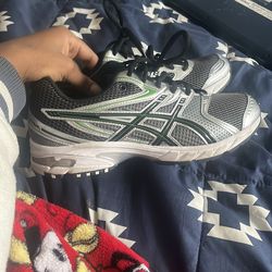 Green and silver asics