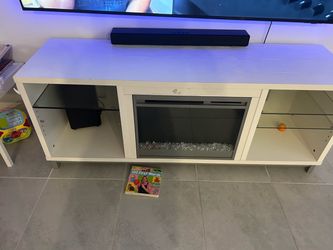 White TV stand with illuminated Fireplace