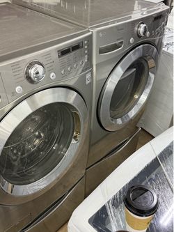 LG   Silver washer and dryer front load with pedestal