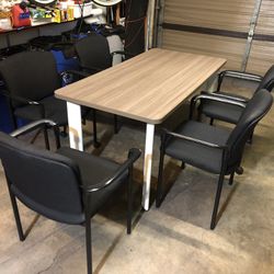Table With 5 Black Cushion Stackable Chairs 
