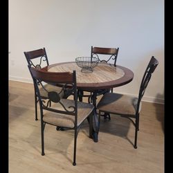 This is an Ashley Furniture Signature Design Glambrey D329-15 round dining table and D329-01 side chairs set with a brown cherry finish top and dark b