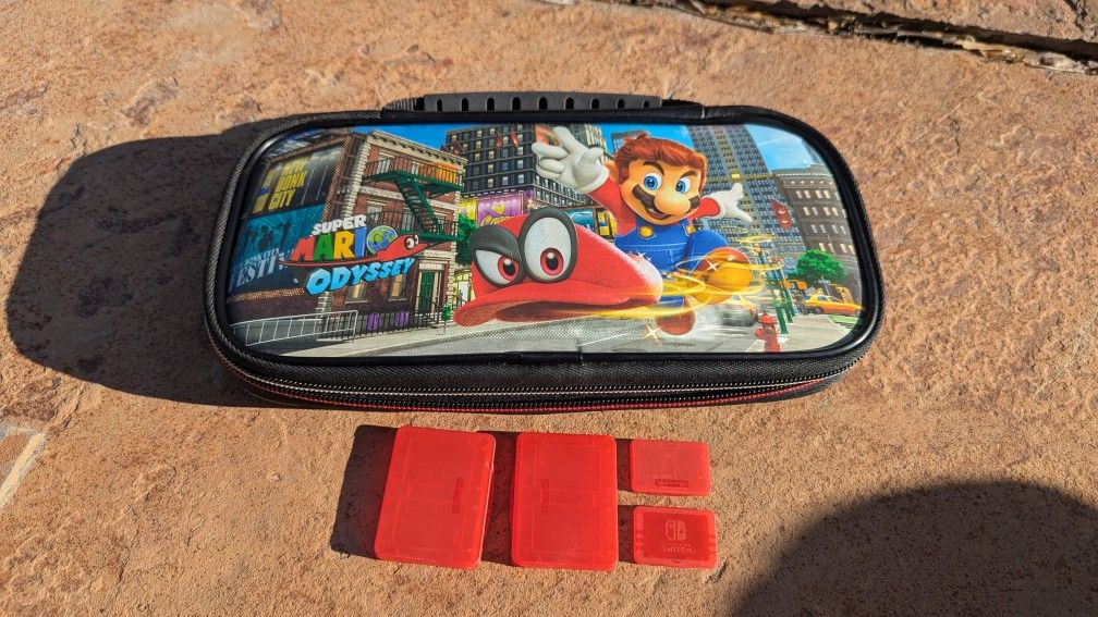 Super Mario Odyssey Padded Deluxe Switch Case. With Game Holders

The case is in good condition. There is one scuff mark on the back. Please see the p