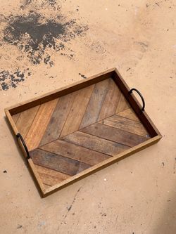 rustic serving tray features a distinctive chevron stripe pattern made from mixed wood