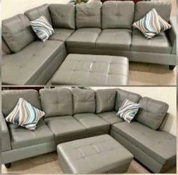Gray leather sectional couch and ottoman