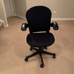 Black Cushioned And Adjustable Desk Chair With Leather Arms And Adjustable Levers