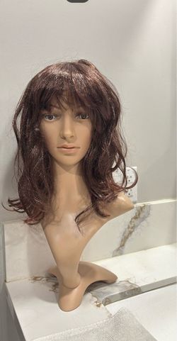 Wavy layered hair wig with bangs.