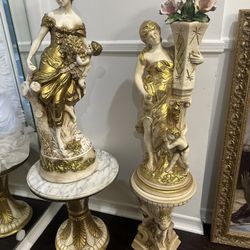Two Set Of Statues With Two Stands 