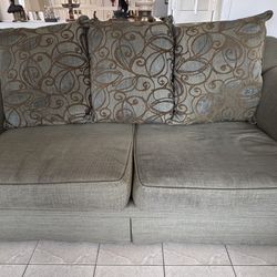 Green Sofa with Patterned Cushions