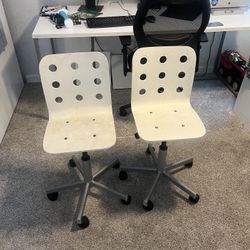 2 white Ikea Jules chairs for kids
