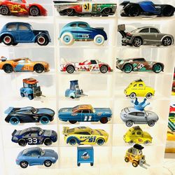 collection of die-cast toy cars from the Disney and Pixar Cars franchise. These vehicles are highly detailed, 1:55 scale models designed to replicate 