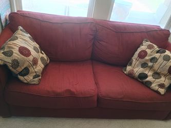 Red sofa with pullout queen bed