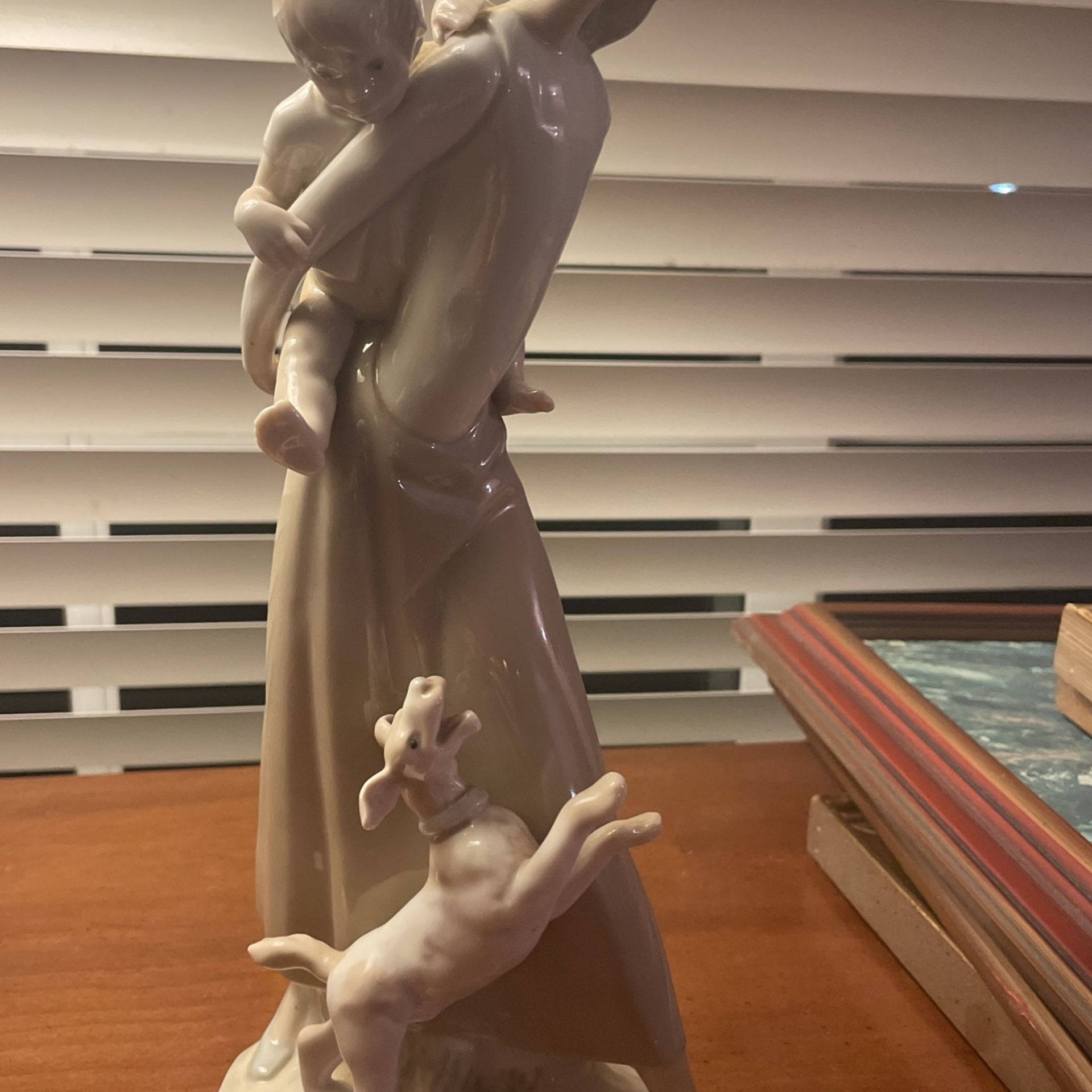 Woman Holding Child Figurine