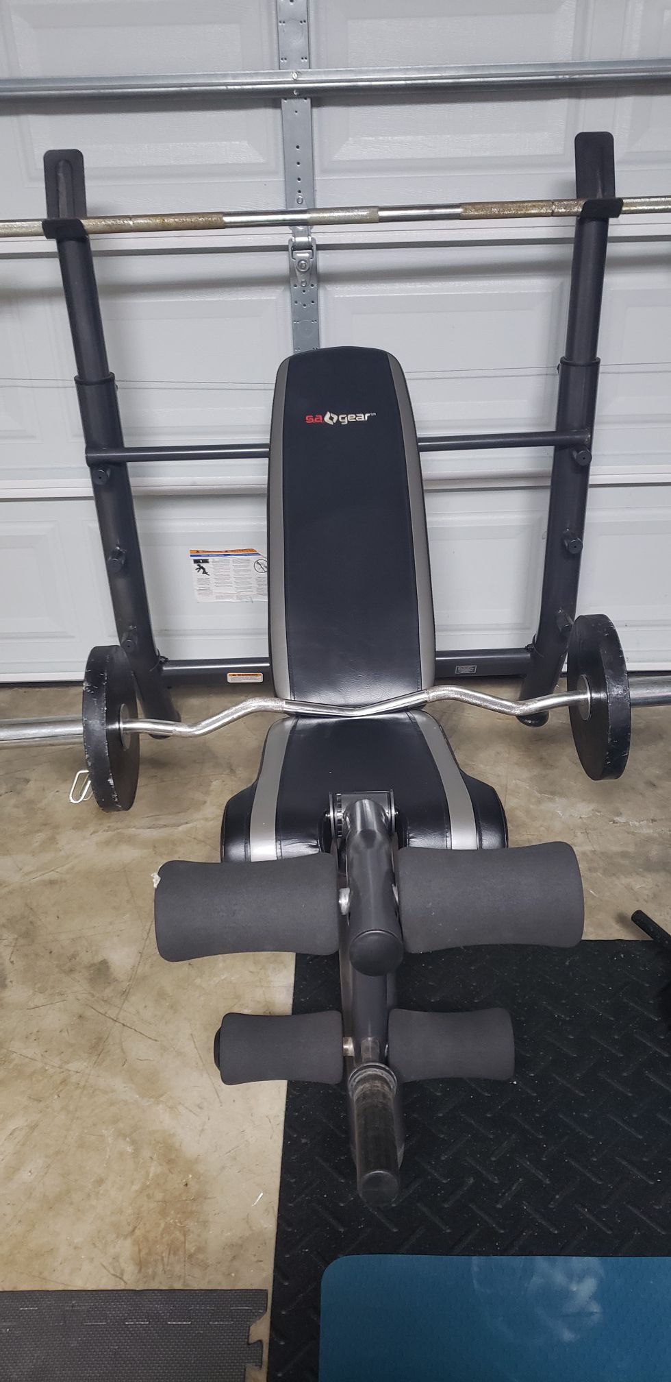 Weight bench with olympic bar. Plates sold at $1 per pound
