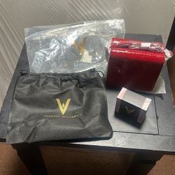 Vanessa Williams purse with a necklace and charm