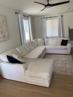Living Spaces Couch Prestige Foam 3 sectional sofa 172in W by 101 L. Caitlyn Flax color, 3 Bella Black Pillows & 3 Mega Ivory Pillows.