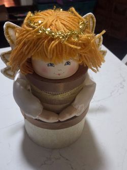 DesignPac, gourmet gift baskets and holiday packages. Adorable handmade angel doll features a creative design built around nested round gift boxes.