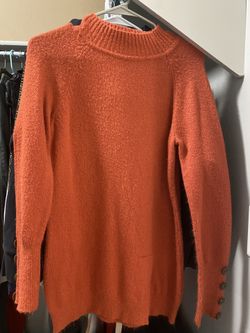 Orange sweater with buttons down the side
