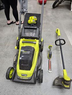 Ryobi mower, trimmer and weed wacker set.