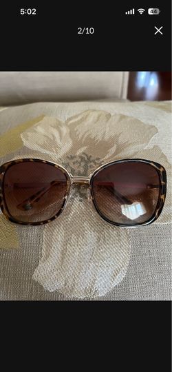 There a beautiful vintage sunglasses the color is brown with some gold around it. The brand is you can hide behind me if you want https://offerup.com/