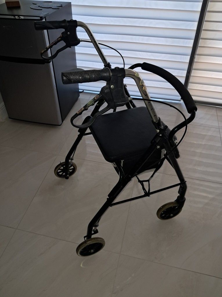 4 wheel walker green and black with basket seat