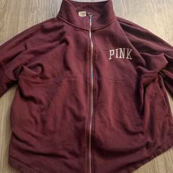 Pink jacket with logo on front and back size large