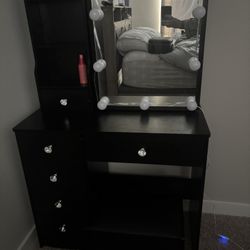 Black vanity with lighted mirror