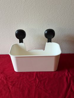 Plastic shower organizer with suction-cup mounting.