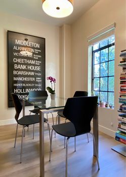 Four black side chairs with metal legs
