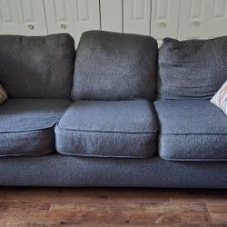 Gray Three-Seat Sofa with Pillows