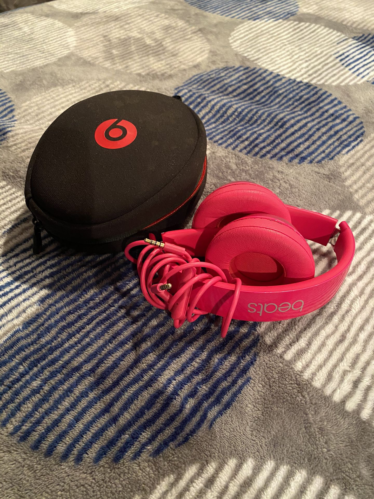 Hot pink wired beats headphones