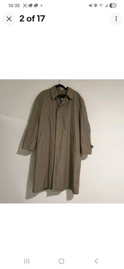classic, single- breasted beige or tan trench coat, likely a vintage London Fog raincoat featuring a point collar and front button closure. Size 50-X 