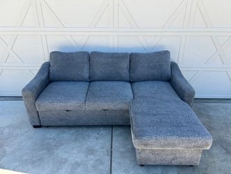 Dark Grey Sectional with Rollout Ottoman and Storage Chaise