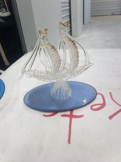 This is a vintage hand-blown glass sailing ship sculpture with gold gilt accents
