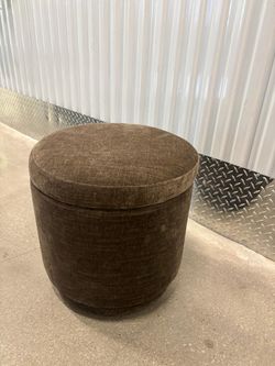 Gray cloth foot stool … in good condition. Swivels With storage space inside . 18 “ round x 17 “ high … $40