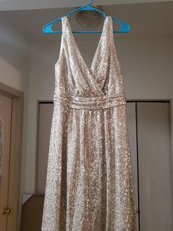 New dress. Paid 200$ asking 125.00 size 12 fits like a 9/10 it's a beautiful light shimmery gold color. NOT the yellow dark gold. Lol.