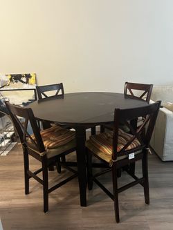 Dining room table includes 4 chairs and cushions