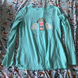 Teal Long Sleeves Shirt With 2 White Narwhals With Gold Sparkles With Sparkles And Shines In The Sky Of The Shirt Where The Narwhals Are Crocheting