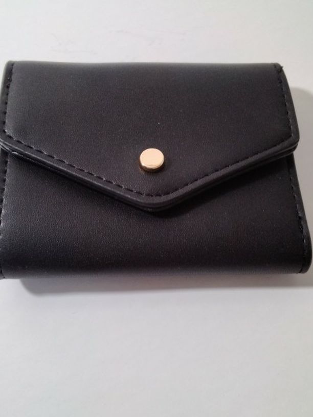 A Nice Brand New Black Wallet For Those Small Purse .